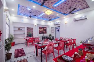 a dining room with red tables and red chairs at Amer Classic - A Heritage Stay Near Amer Fort in Jaipur