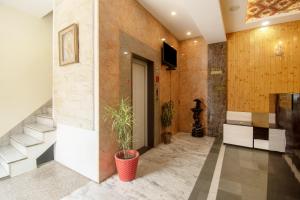 a hallway with a plant in a red pot at Amer Classic - A Heritage Stay Near Amer Fort in Jaipur