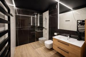 a bathroom with a shower and a toilet and a sink at Hotel Restauracja Caspar in Jelenia Góra +58 photos