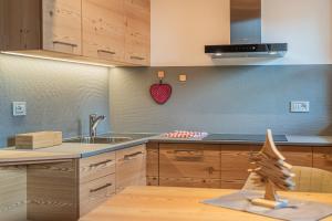 a kitchen with a sink and a counter top at The Love Chalet in Falcade