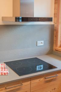 a kitchen with a stove top oven in a kitchen at The Love Chalet in Falcade