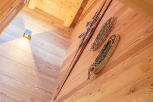 two snakes on the floor of a wooden floor at The Love Chalet in Falcade +18 photos