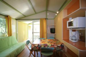 a living room with a table and a couch at Camping Dolce Vita in Calvi
