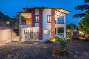 a home with a large house with a roof at SaffronStays Casa Amore in Mahabaleshwar