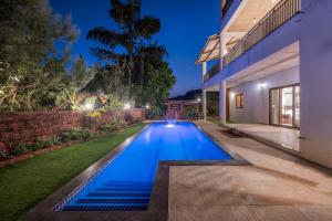 a swimming pool in the backyard of a house at SaffronStays Casa Amore in Mahabaleshwar