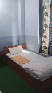 a bed with two towels sitting on top of it at B N Hotel & Restaurant in Rāmechhāp