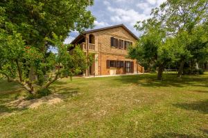 a large brick house with trees in front of it at Agriturismo Terralieta in Roseto degli Abruzzi