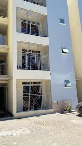 a white building with scaffolding on its windows at GCG STAYS ltd in Mtwapa