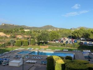 a view of a parking lot with a pool at Apartamento Rosa in Cala Bona