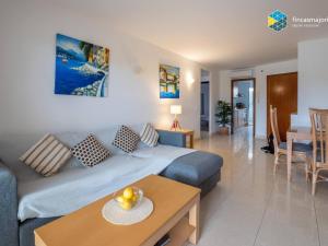a living room with a couch and a table at Apartamento Rosa in Cala Bona