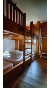 two bunk beds in a room with wooden floors at Auberge de l'eau rousse in La Léchère