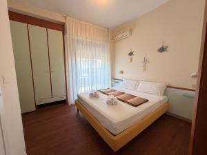 a bedroom with a bed with two towels on it at MH Hotel Maracaibo in Rimini