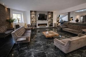 a living room with couches and a fireplace at Fleiš Residence villa - jacuzzi included in Most