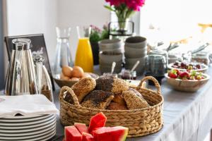 a table topped with a basket of bread and fruit at Aggersvold Gods in Jyderup +23 photos