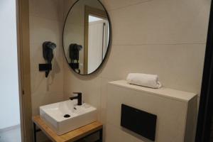a bathroom with a sink and a mirror at Hotel Ram Rooms Tahiti in Salou +17 photos