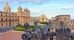 a view of the city from the balcony of a building at DOMUS Canonico in Noto