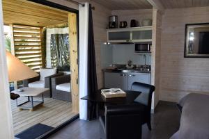 a small room with a kitchen and a living room at Timazen Lodges Agen Sud in Aubiac