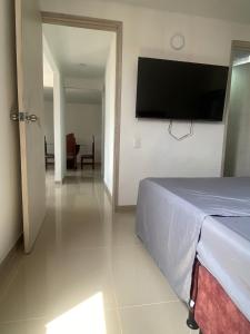 a bedroom with a bed and a flat screen tv at casa trieste in Jamundí