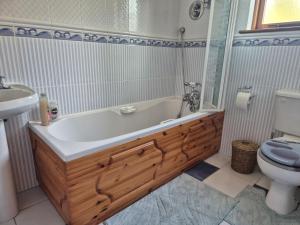 a bathroom with a tub and a toilet and a sink at Harbour View Lodge in Dromod +8 photos