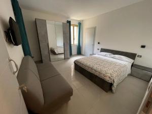 a bedroom with a bed and a mirror and a couch at Rifugio Urbano in Terni +15 photos