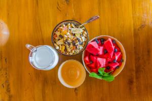 a table with a bowl of fruit and a bowl of milk at Ikhaya Safari Lodge in Cape Town +101 photos
