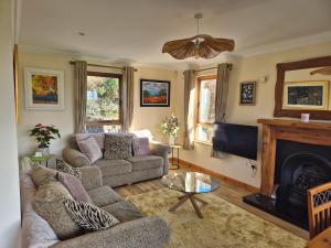 a living room with a couch and a fireplace at Harbour View Lodge in Dromod