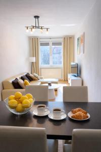 a living room with a table with a bowl of fruit on it at Plac 14- Apartamenty i pokoje w centrum in Świnoujście