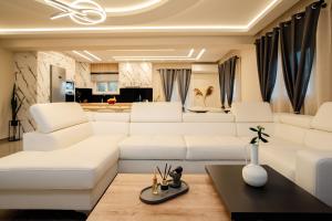 a living room with a white couch and a table at Luxury Villa Kokos-Private Pool in a Serene Natural Private Estate in Vitalades