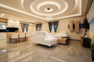 a living room with a white couch and a table at Luxury Villa Kokos-Private Pool in a Serene Natural Private Estate in Vitalades