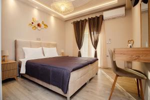 a bedroom with a bed and a desk in it at Luxury Villa Kokos-Private Pool in a Serene Natural Private Estate in Vitalades +39 photos