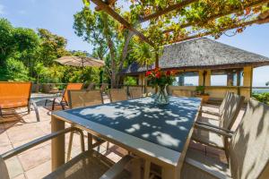 a table and chairs on a patio with a gazebo at Ikhaya Safari Lodge in Cape Town