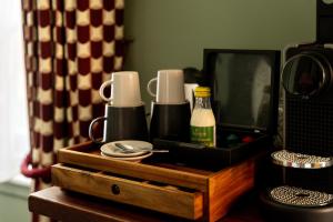 a wooden box with cups and a mirror on a table at The Bull Hotel in Bridport