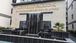 a water fountain in front of a building at Oceania Suites 5 Minutes from Jomo Kenyatta international Airport in Nairobi