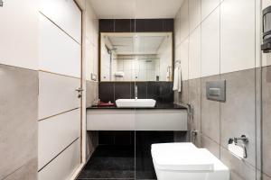 a bathroom with a toilet and a sink at Mango Hill Hotel Velankanni in Velankanni