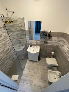 a bathroom with a sink and a toilet and a shower at Rifugio Urbano in Terni