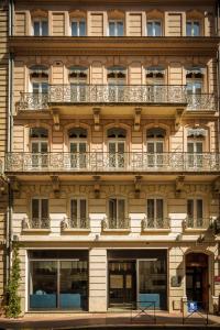 a building with balconies on the side of it at Hotel Albert 1er in Toulouse