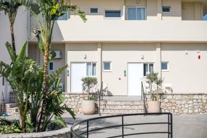 a black chair in front of a building at Olevia Comfort in Faliraki