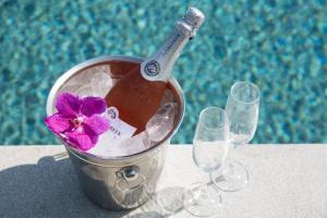 a bucket with a bottle of champagne and two glasses at Villa Danisa 4BR Panoramic Ocean View with Infinity Pool & Private Gym in Choeng Mon Beach