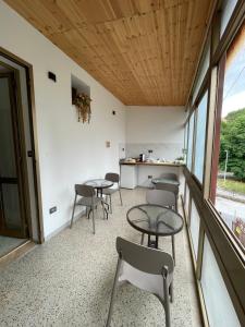a room with tables and chairs and windows at Rifugio Urbano in Terni