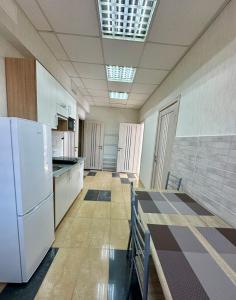 an empty room with a kitchen with white appliances at Апартаменти Пасаж 2 in Skhidnitsa +5 photos