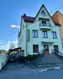 a white house with stairs in front of it at Апартаменти Пасаж 2 in Skhidnitsa