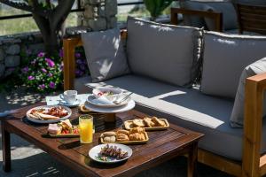 a table with plates of food and drinks on it at Olevia Comfort in Faliraki