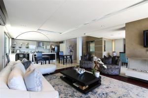 a living room with a white couch and a table at Azamare Guest House in Cape Town