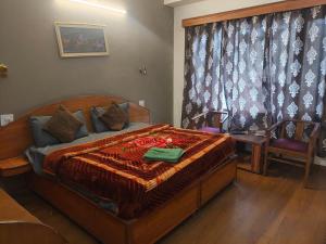 a bedroom with a large wooden bed in a room at Hotel Shree Ram in Shimla