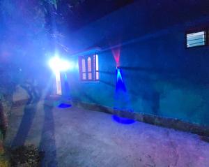 a house with a light on the side of it at night at Rd resort in Jāmb