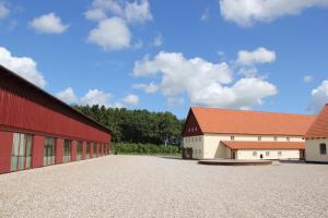 a red and white barn with a red roof at Aggersvold Gods in Jyderup