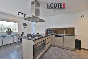 a kitchen with a sink and a stove top oven at Villa Laterra in Ensuès-la-Redonne +15 photos