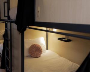 a bed with a pillow sitting on top of it at Revolver Edinburgh in Edinburgh +88 photos