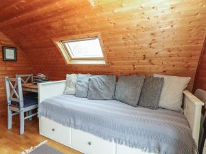 a bedroom with a bed in a wooden cabin at Grape Escape in Halesworth