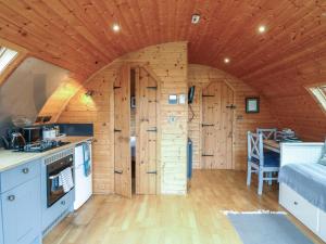 a kitchen and living room in a log cabin at Grape Escape in Halesworth